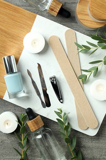 concept of nail care with manicure accessories on wooden background